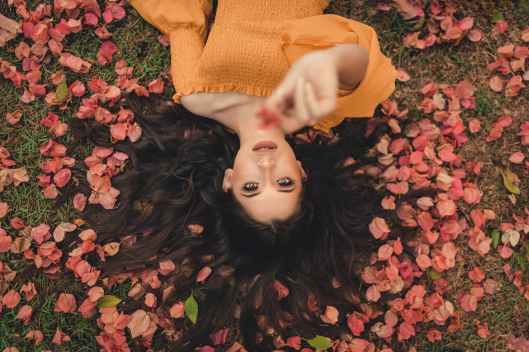 photo of woman laying on ground